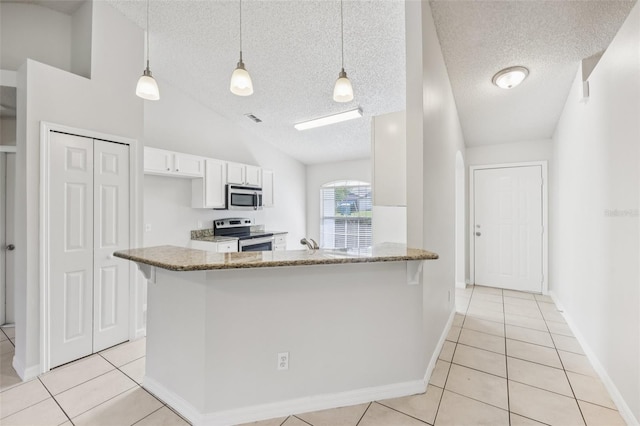 1082 Worthington Dr, Deltona, FL 32738 - kitchen featuring appliances with stainless steel finishes, white cabinets, light tile patterned floors, stone counters, and a textured ceiling