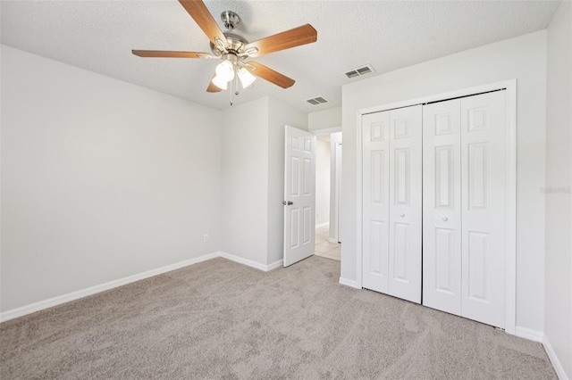1082 Worthington Dr, Deltona, FL 32738 - unfurnished bedroom with carpet flooring, a closet, a textured ceiling, and a ceiling fan