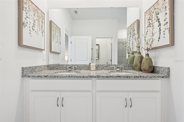 1275 Normandy Dr, Haines City, FL 33844 - bathroom featuring double vanity and a shower
