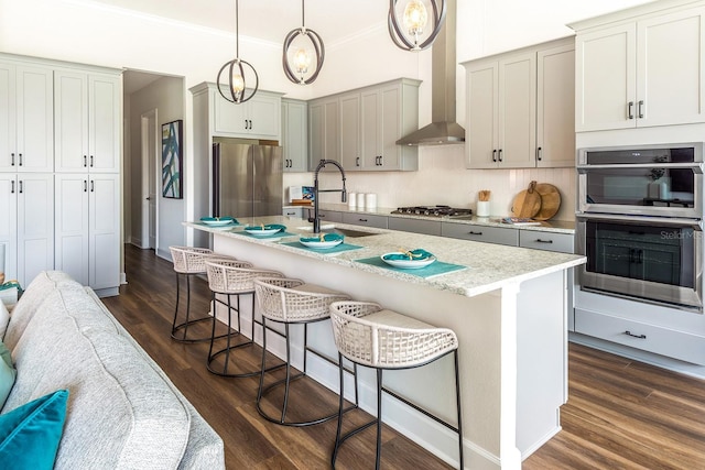 1085 Signet, Apollo Beach, FL 33572 - kitchen featuring stainless steel appliances, wall chimney exhaust hood, crown molding, a kitchen breakfast bar, and dark wood-style floors