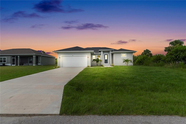9333 Hialeah Ter, Port Charlotte, FL 33981 - prairie-style house with a garage, driveway, a yard, and stucco siding