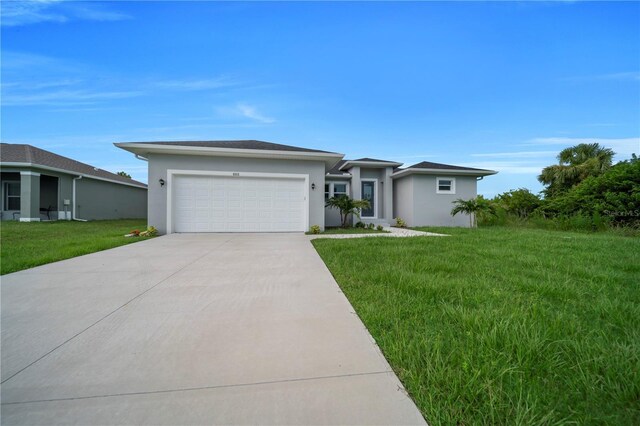 9333 Hialeah Ter, Port Charlotte, FL 33981 - prairie-style house with driveway, stucco siding, a garage, and a front lawn