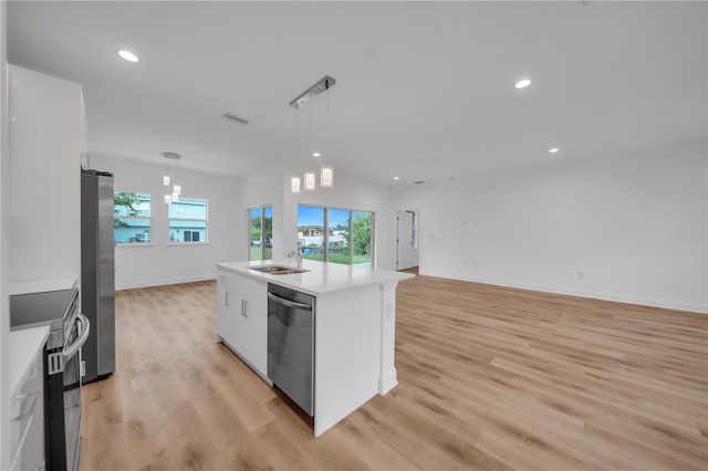 9333 Hialeah Ter, Port Charlotte, FL 33981 - kitchen with appliances with stainless steel finishes, light wood-style floors, light countertops, white cabinetry, and decorative light fixtures