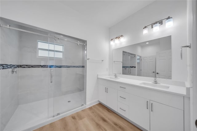 9333 Hialeah Ter, Port Charlotte, FL 33981 - full bath with a stall shower, double vanity, and wood finished floors