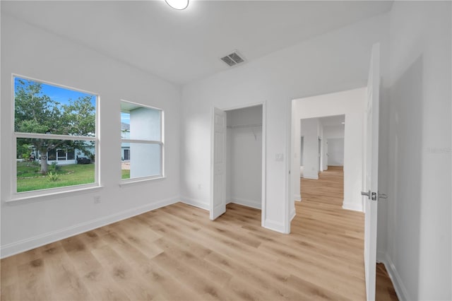 9333 Hialeah Ter, Port Charlotte, FL 33981 - unfurnished bedroom with light wood-style flooring and a closet