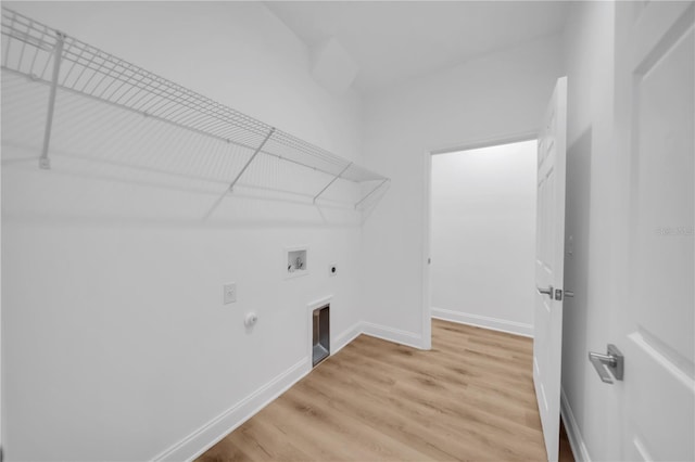 9333 Hialeah Ter, Port Charlotte, FL 33981 - laundry area featuring hookup for a gas dryer, hookup for an electric dryer, hookup for a washing machine, and light wood-style flooring