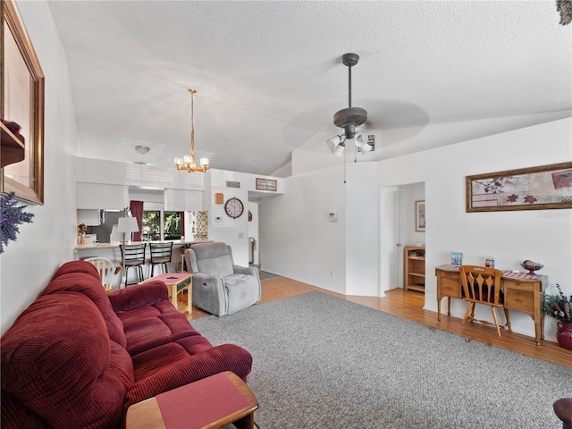 5421 Lake Margaret Dr Unit 178, Orlando, FL 32812 - living room with lofted ceiling, a ceiling fan, wood finished floors, a chandelier, and a textured ceiling