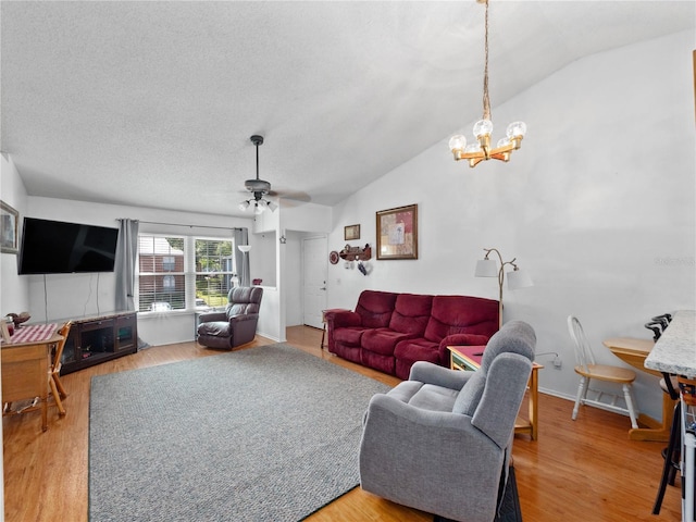 5421 Lake Margaret Dr Unit 178, Orlando, FL 32812 - living area featuring vaulted ceiling, a chandelier, wood finished floors, a ceiling fan, and a textured ceiling