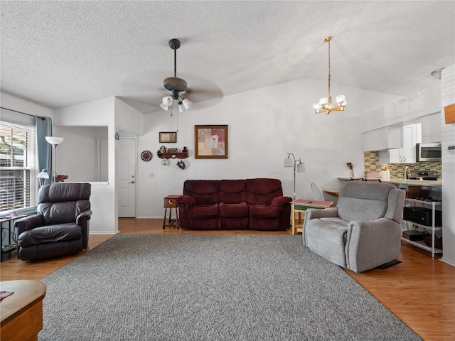 5421 Lake Margaret Dr Unit 178, Orlando, FL 32812 - living area featuring lofted ceiling, ceiling fan, light wood-style flooring, a chandelier, and a textured ceiling