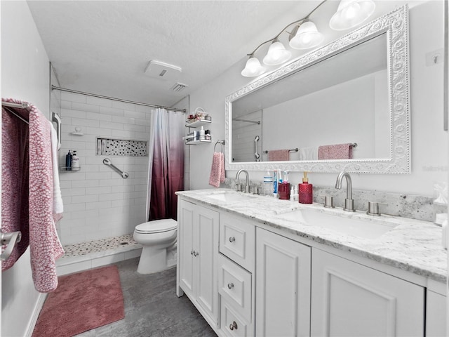 5421 Lake Margaret Dr Unit 178, Orlando, FL 32812 - full bathroom featuring a tile shower, double vanity, wood finished floors, and a textured ceiling