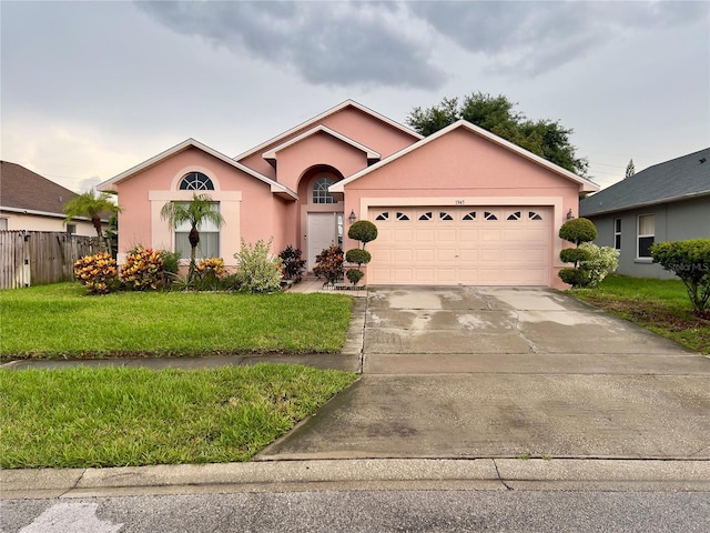 1945 Torrey Dr, Orlando, FL 32818 - ranch-style house with stucco siding, a garage, and concrete driveway