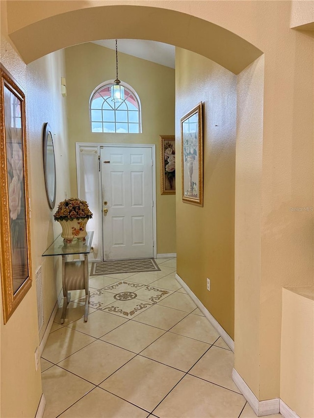 1945 Torrey Dr, Orlando, FL 32818 - entryway featuring arched walkways, lofted ceiling, and light tile patterned floors