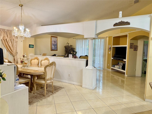 1945 Torrey Dr, Orlando, FL 32818 - dining area featuring light tile patterned floors, a textured ceiling, a chandelier, and arched walkways