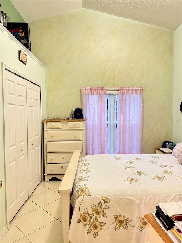 1945 Torrey Dr, Orlando, FL 32818 - bedroom featuring light tile patterned floors, a closet, and vaulted ceiling