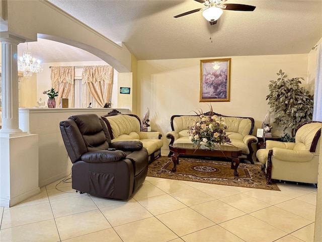 1945 Torrey Dr, Orlando, FL 32818 - living area featuring ornate columns, ceiling fan, light tile patterned flooring, a textured ceiling, and a chandelier