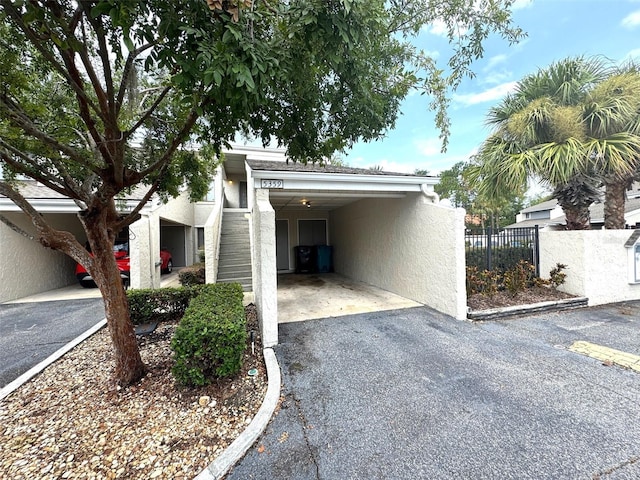 5359 Vineland Rd Unit S, Orlando, FL 32811 - view of side of home with stucco siding, stairway, and driveway