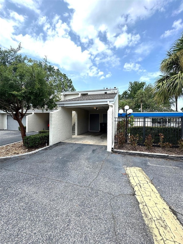 5359 Vineland Rd Unit S, Orlando, FL 32811 - view of building exterior featuring driveway and an attached carport