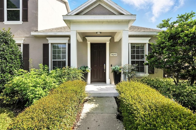 14241 Confetti Dr, Windermere, FL 34786 - property entrance with stucco siding and roof with shingles