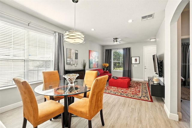 14241 Confetti Dr, Windermere, FL 34786 - dining area featuring light wood-style floors, arched walkways, recessed lighting, and a ceiling fan