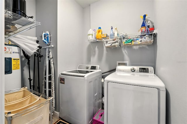 14241 Confetti Dr, Windermere, FL 34786 - laundry room with washing machine and dryer and electric water heater