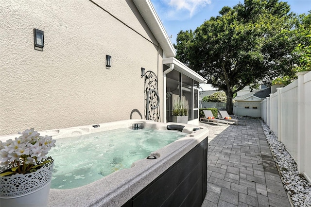 14241 Confetti Dr, Windermere, FL 34786 - fenced backyard featuring a hot tub, a sunroom, and a patio
