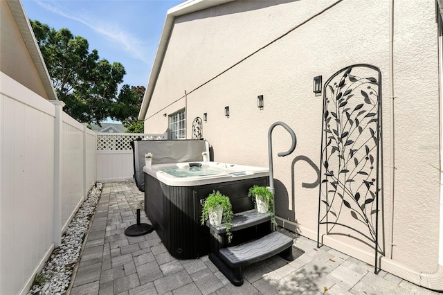 14241 Confetti Dr, Windermere, FL 34786 - fenced backyard with a hot tub and a patio