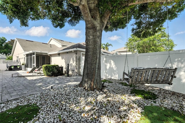 14241 Confetti Dr, Windermere, FL 34786 - rear view of house with a sunroom, a patio area, and stucco siding