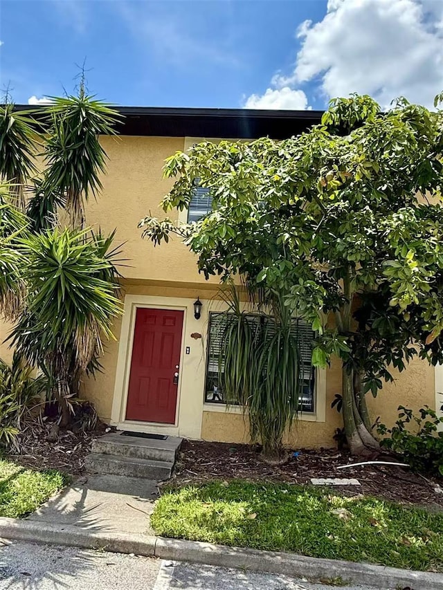 3370 Cedar Springs Pl Unit 156, Winter Park, FL 32792 - view of exterior entry with stucco siding