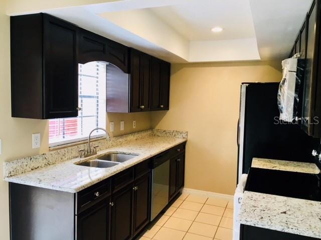 3370 Cedar Springs Pl Unit 156, Winter Park, FL 32792 - kitchen featuring dishwasher, a tray ceiling, dark cabinets, white microwave, and light tile patterned floors