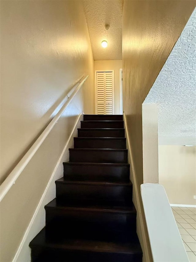 3370 Cedar Springs Pl Unit 156, Winter Park, FL 32792 - stairs featuring a textured ceiling and tile patterned flooring