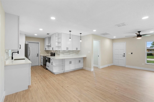 5310 Pineview Way, Apopka, FL 32703 - kitchen featuring open shelves, appliances with stainless steel finishes, light wood-style flooring, light countertops, and recessed lighting
