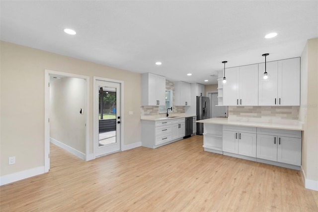 5310 Pineview Way, Apopka, FL 32703 - kitchen featuring stainless steel refrigerator with ice dispenser, dishwasher, decorative backsplash, light countertops, and white cabinetry