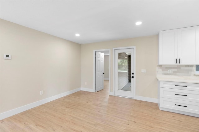 5310 Pineview Way, Apopka, FL 32703 - kitchen with light wood-style floors, white cabinetry, recessed lighting, light countertops, and backsplash
