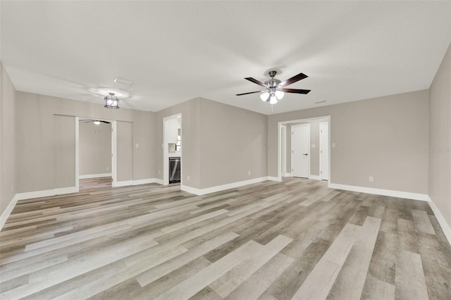1838 Windmill Dr, Orlando, FL 32818 - unfurnished living room featuring ceiling fan and light wood finished floors
