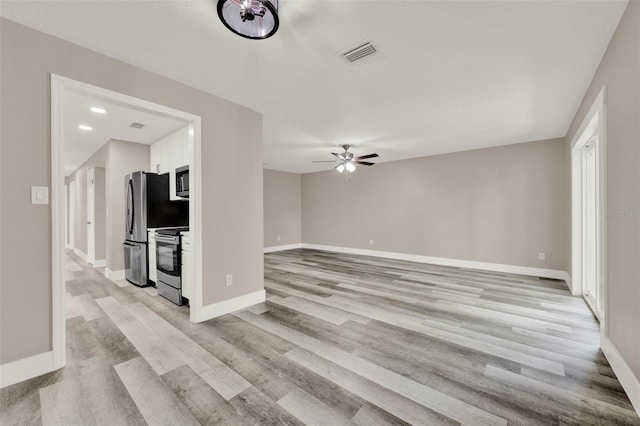 1838 Windmill Dr, Orlando, FL 32818 - unfurnished living room with light wood-style flooring and a ceiling fan