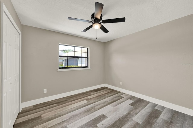 1838 Windmill Dr, Orlando, FL 32818 - unfurnished bedroom featuring wood finished floors, a closet, a textured ceiling, and a ceiling fan