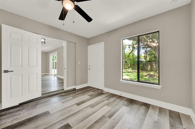 1838 Windmill Dr, Orlando, FL 32818 - empty room featuring plenty of natural light, a ceiling fan, and wood finished floors