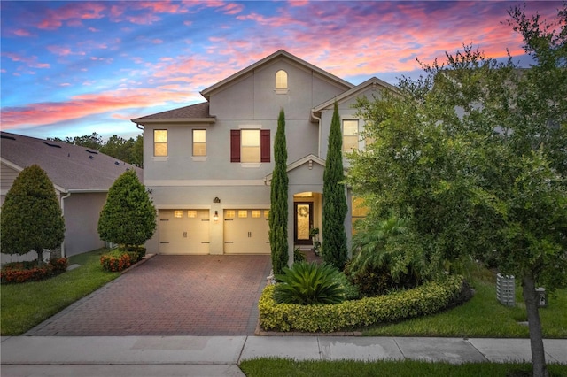 9518 Bolero Rd, Winter Garden, FL 34787 - view of front of home with stucco siding, decorative driveway, and a garage
