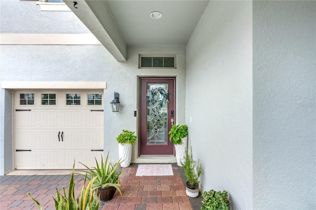9518 Bolero Rd, Winter Garden, FL 34787 - doorway to property featuring stucco siding and a garage