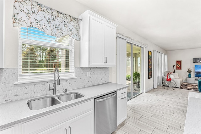 9518 Bolero Rd, Winter Garden, FL 34787 - kitchen featuring dishwasher, plenty of natural light, backsplash, and white cabinetry