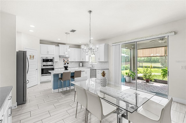 9518 Bolero Rd, Winter Garden, FL 34787 - dining space with a chandelier, ceiling fan, recessed lighting, and light wood finished floors