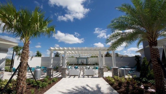 9518 Bolero Rd, Winter Garden, FL 34787 - fenced backyard with a patio, a pergola, and outdoor lounge area