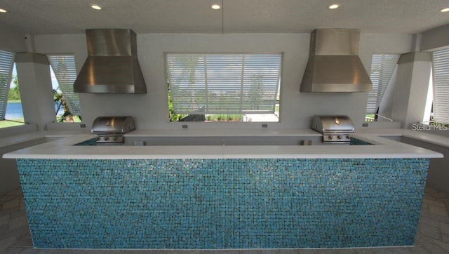 9518 Bolero Rd, Winter Garden, FL 34787 - kitchen featuring wall chimney range hood and recessed lighting
