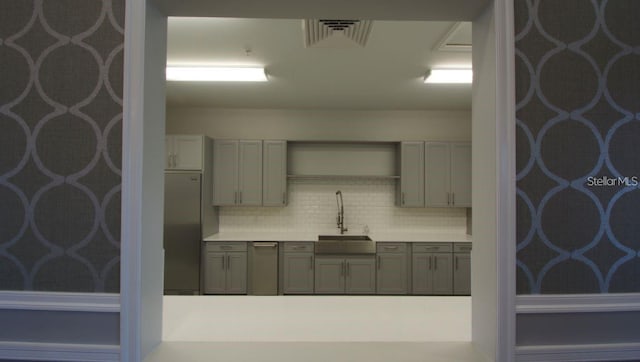 9518 Bolero Rd, Winter Garden, FL 34787 - kitchen featuring decorative backsplash, light countertops, refrigerator, and stainless steel dishwasher