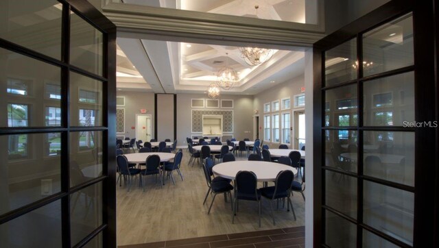 9518 Bolero Rd, Winter Garden, FL 34787 - dining area featuring a chandelier, coffered ceiling, and dark wood-type flooring