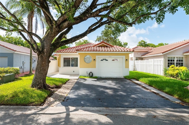 13412 NW 5th Ct, Plantation, FL 33325 - mediterranean / spanish house with stucco siding, an attached garage, a tile roof, and driveway