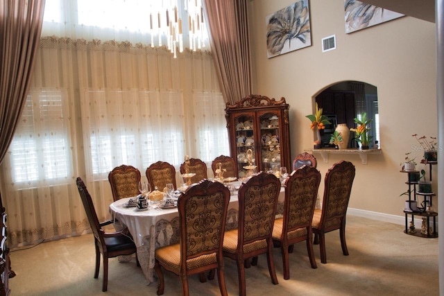 2851 Swoop Cir, Kissimmee, FL 34741 - dining area with carpet floors and arched walkways
