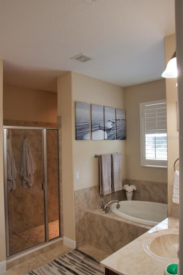 2851 Swoop Cir, Kissimmee, FL 34741 - full bathroom featuring vanity, a bath, a stall shower, and tile patterned flooring