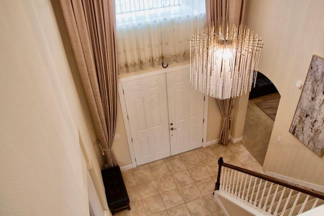 2851 Swoop Cir, Kissimmee, FL 34741 - foyer entrance featuring a chandelier and light tile patterned flooring