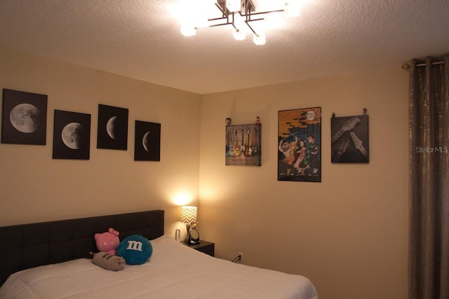 2851 Swoop Cir, Kissimmee, FL 34741 - bedroom with a chandelier and a textured ceiling